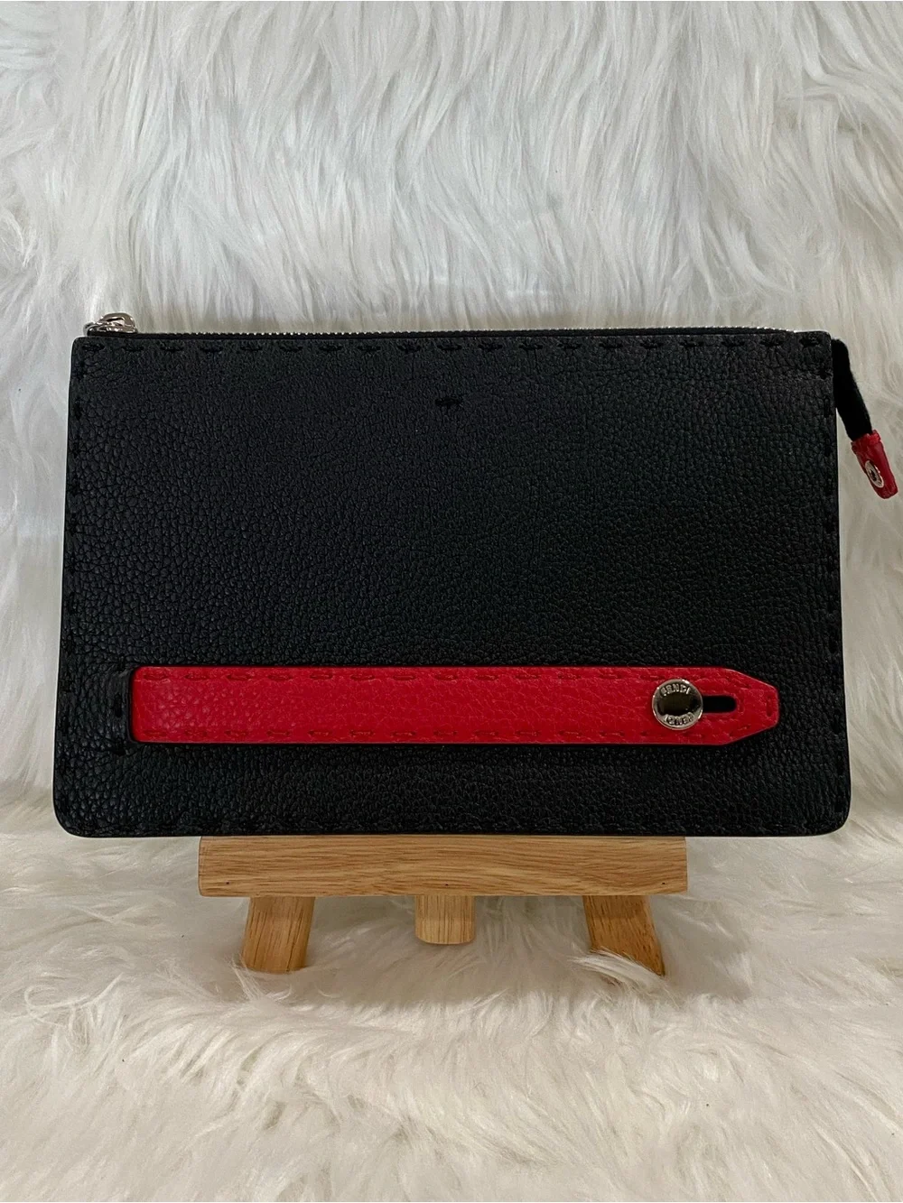 Fendi Selleria flat clutch bag with red stitching and red leather handle